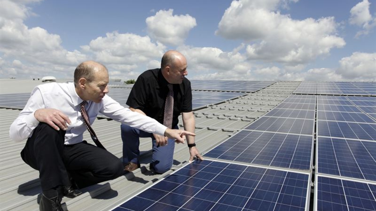 Julian Colman and MD Graham Denny survey the new solar roof panels Julian Colman and MD Graham Denny survey the new solar roof panels