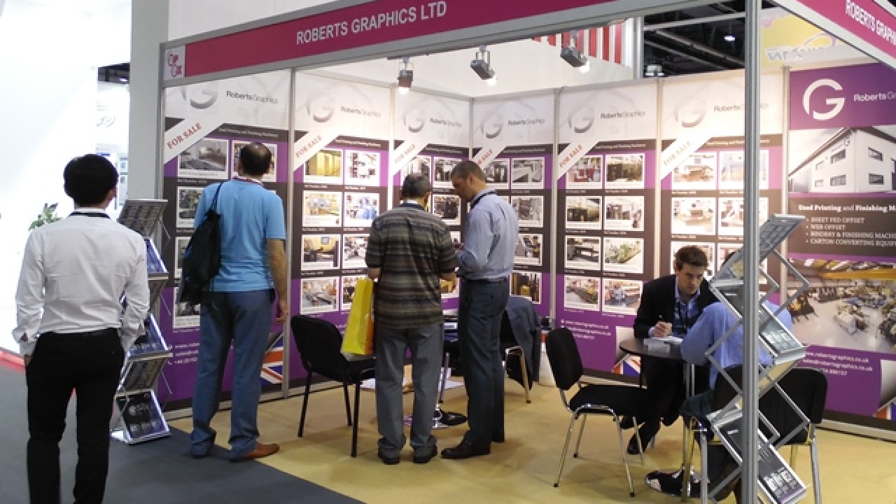 An area of the Gulf Print & Pack 2015 show floor, noticeable by its magenta color scheme, is hosting 19 used machinery dealers from global markets who are sharing 14 stands.