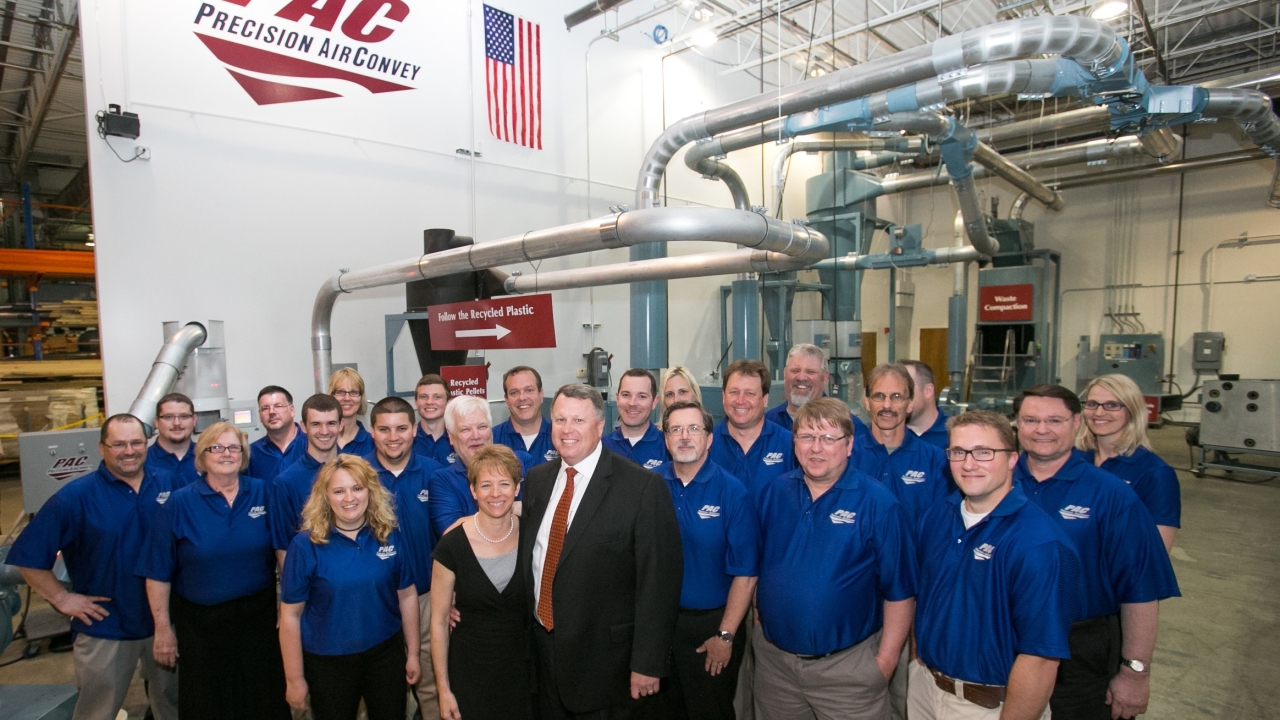 PAC team photo in front of matrix waste removal equipment