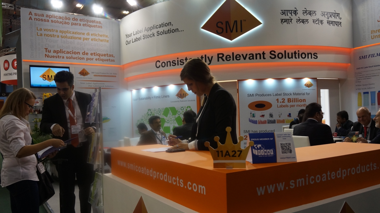 Rohit Mehta, director at SMI Coated Products, in discussion with vistors at the company's stand during Labelexpo Europe 2015