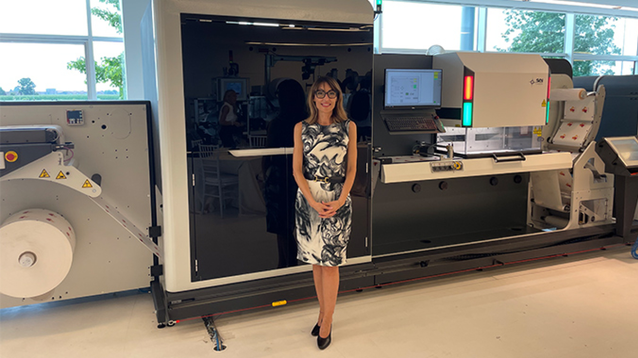 Chiara Prati in front of DIGIFASTone with digital coating module followed by laser die cutting module  