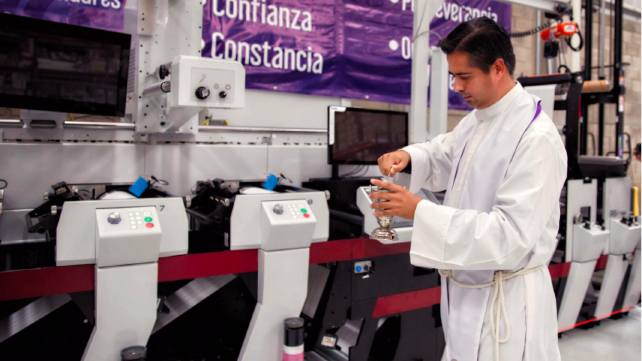 A Catholic priest blessed a new Mark Andy press installed at Etipress