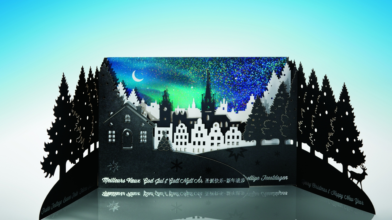 Iggesund Paperboard has continued with its annual tradition of acting as an ‘ambassador for paperboard’ as a material and to display various printing techniques with its 2014 Christmas card showcasing a forest setting and the city of Stockholm profiled against a sky gleaming with the northern lights Iggesund Paperboard has continued with its annual tradition of acting as an ‘ambassador for paperboard’ as a material and to display various printing techniques with its 2014 Christmas card showcasing a forest setting and the city of Stockholm profiled against a sky gleaming with the northern lights