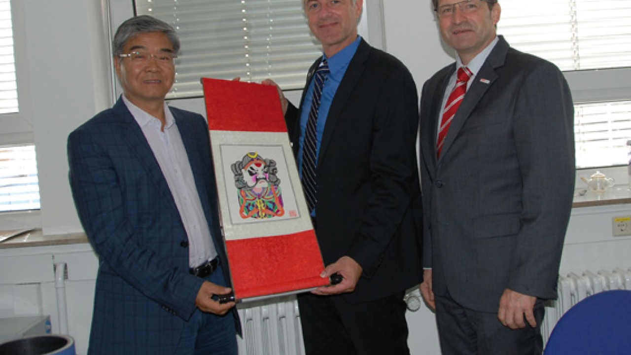 Pictured (from left): Professor Xu Wencai, vice-president of the Beijing Institute of Graphic, presented a Chinese scroll painting to Dr Uwe Stebani, vice-president, technology, and Thomas Leuschner, technical representative, at Flint Group Flexographic Products