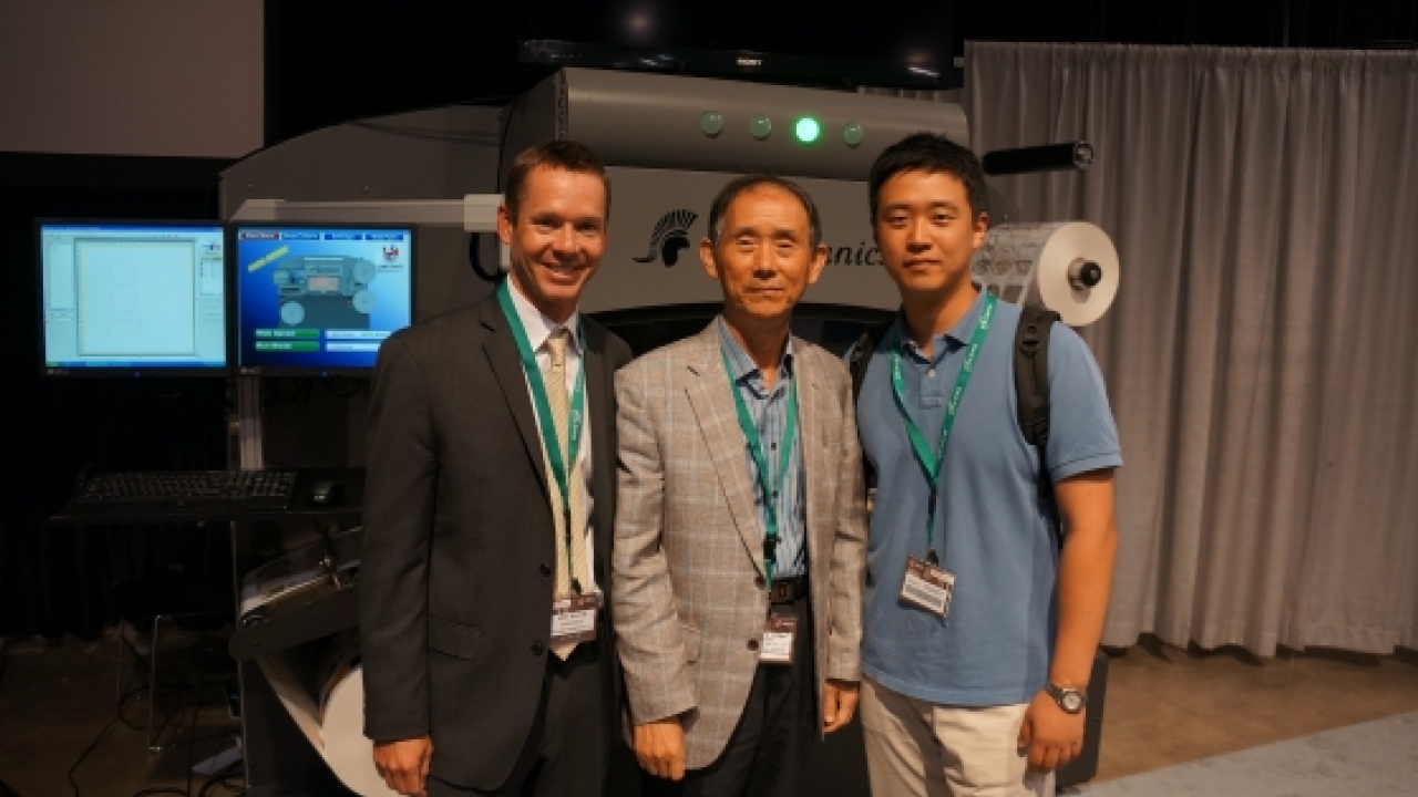 Mike Bacon, vice-president of sales and marketing at Spartanics (left), with representatives from Hana Graphic Art Company, whihc purchased an L-350 at Labelexpo Americas 2012 Mike Bacon, vice-president of sales and marketing at Spartanics (left), with representatives from Hana Graphic Art Company