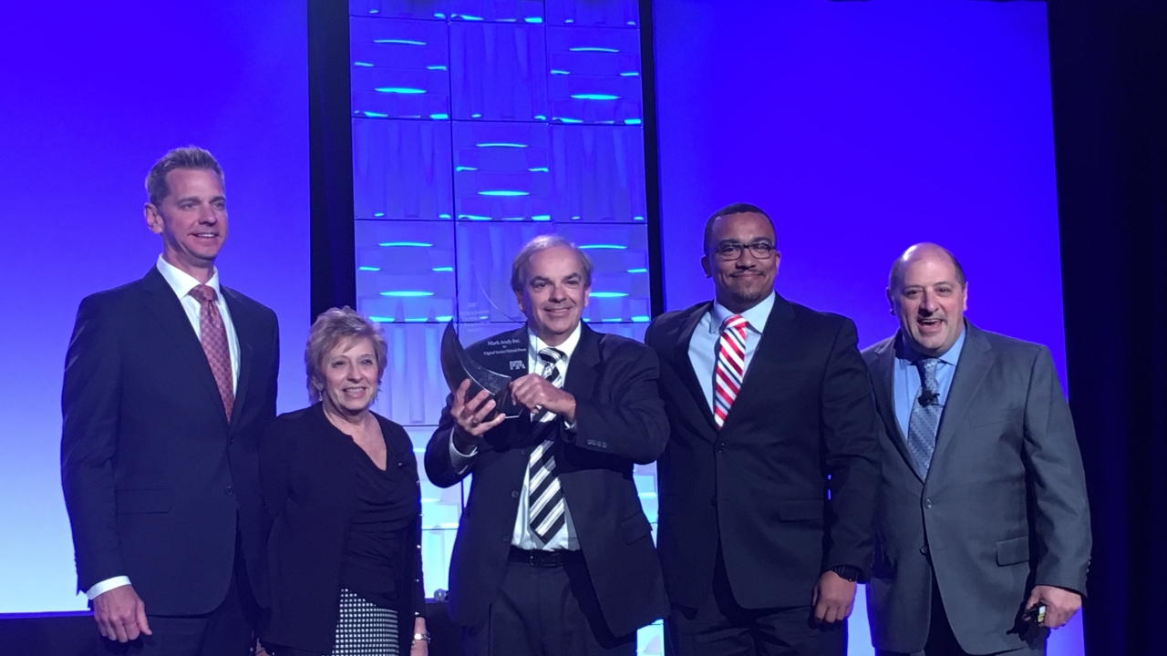 Joe Tuccitto, Director of Education, and Shelley Rubin, Manager of Educational Services, present the FTA Technical Innovation Award in the Heavy Equipment Category to Mark Andy's Steve Schulte, Ray Dickinson, and Joe Calmese. 