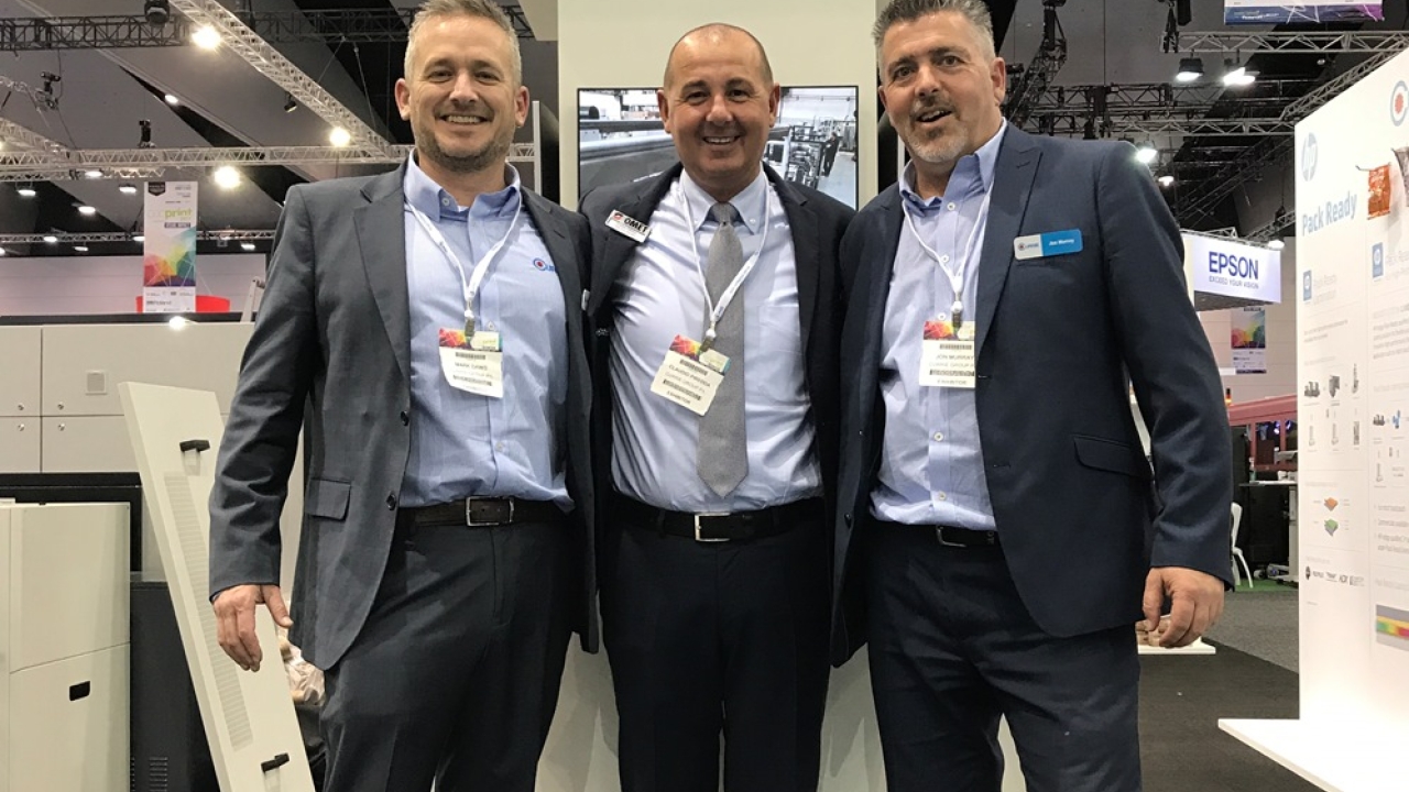 Pictured (from left): Mark Daws, Currie Group labels and packaging division general manager; Omet area sales manager Claudio Piredda; and Currie Group technical manager Jon Murray, pictured at PacPrint 2017 Pictured (from left): Mark Daws, Currie Group labels and packaging division general manager; Omet area sales manager Claudio Piredda; and Currie Group technical manager Jon Murray, pictured at PacPrint 2017