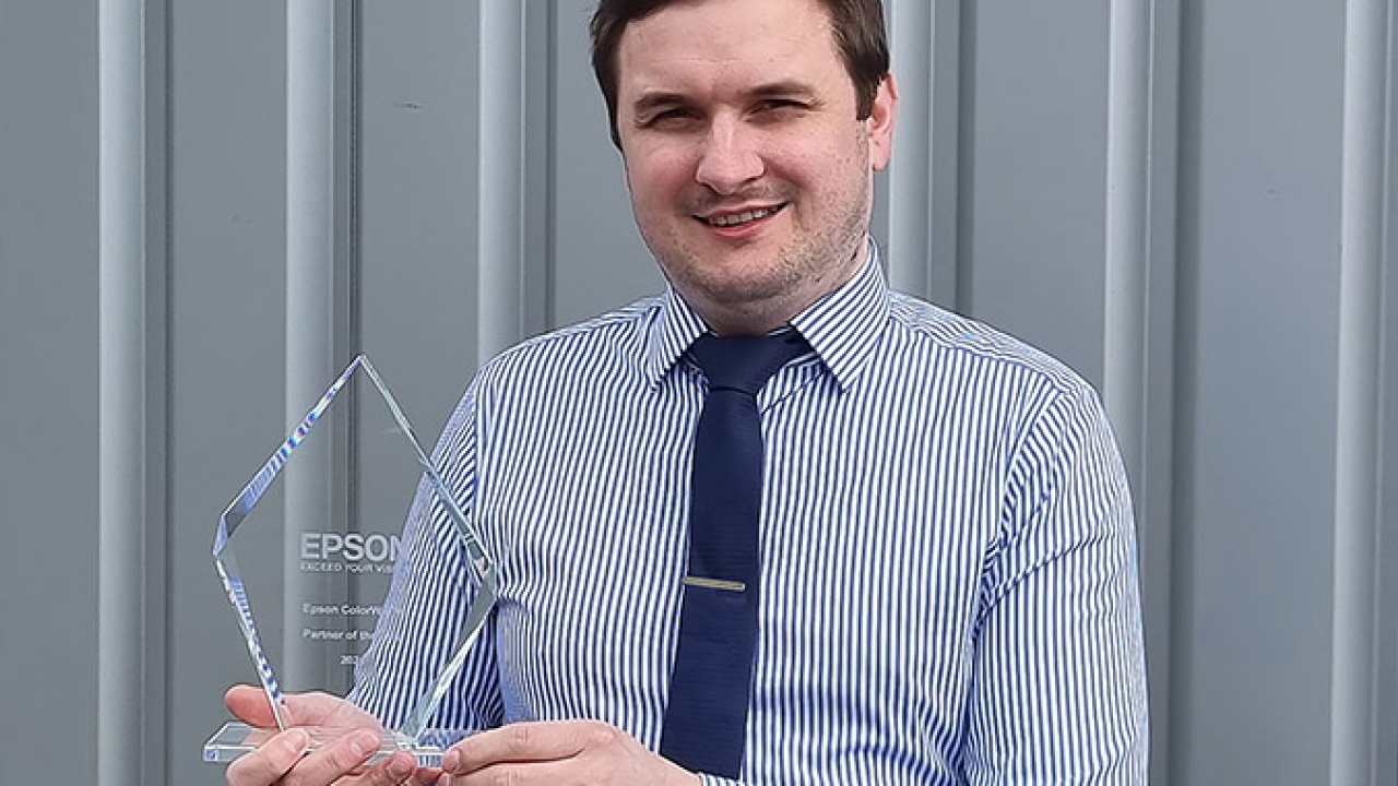 Brendon Bass, sales and marketing manager at AM Labels with the Partner of the Year Award, received from Epson