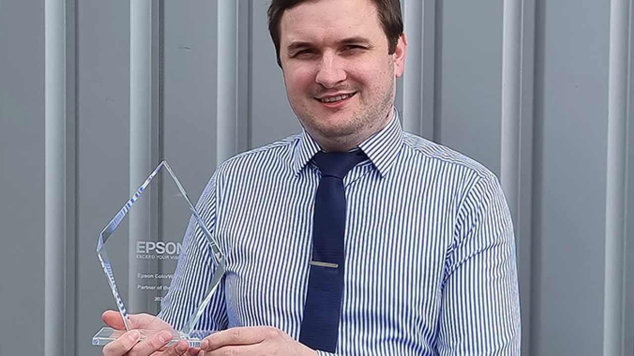 Brendon Bass, sales and marketing manager at AM Labels with the Partner of the Year Award, received from Epson Brendon Bass, sales and marketing manager at AM Labels with the Partner of the Year Award, received from Epson