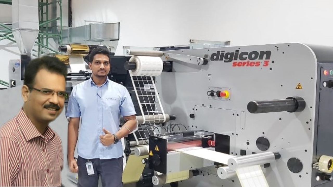 Niraj Darji, president of Astron Packaging (L) inspects ABG Digicon Series 3 with Nitin Thakur of Vinsak