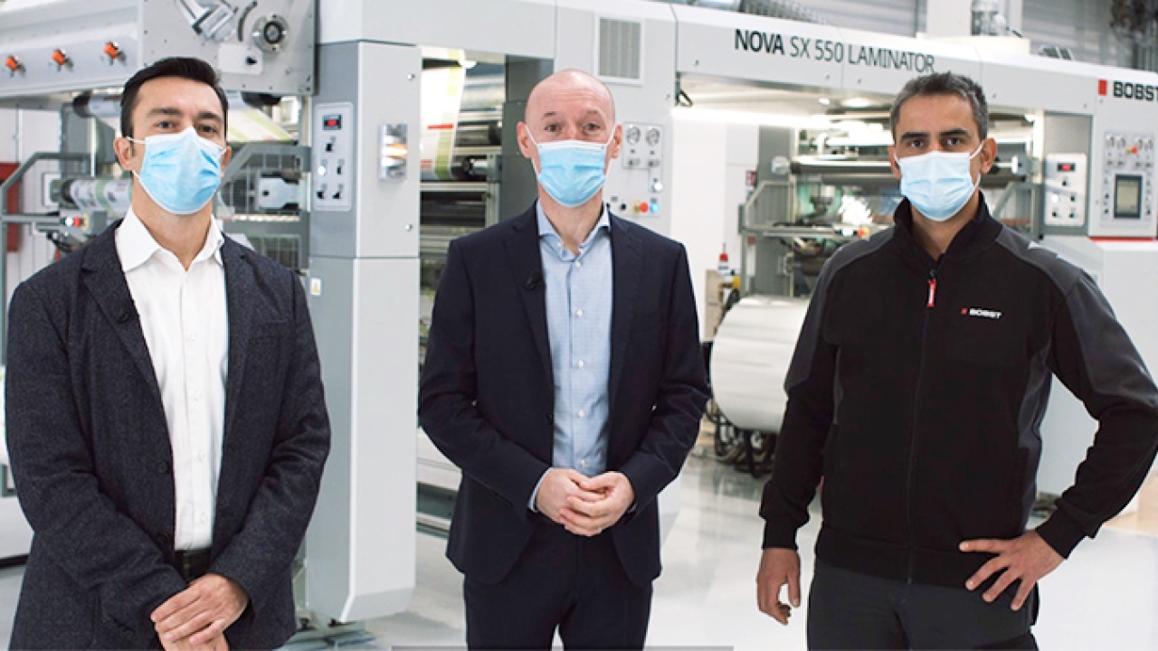 L-R: Ivano Andrighetto, product sales specialist, laminating; Nanni Bertorelli, product line manager, coating and laminating; and Damiano Zinelli, process laminating specialist, in front of the Bobst Nova SX 550 laminator.