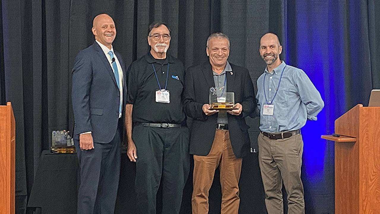 Kurt Oegerli, sales manager of Bobst North America, receiving the Golden Cylinder Award for Technical Innovation at the AIMCAL 2022 R2R Conference