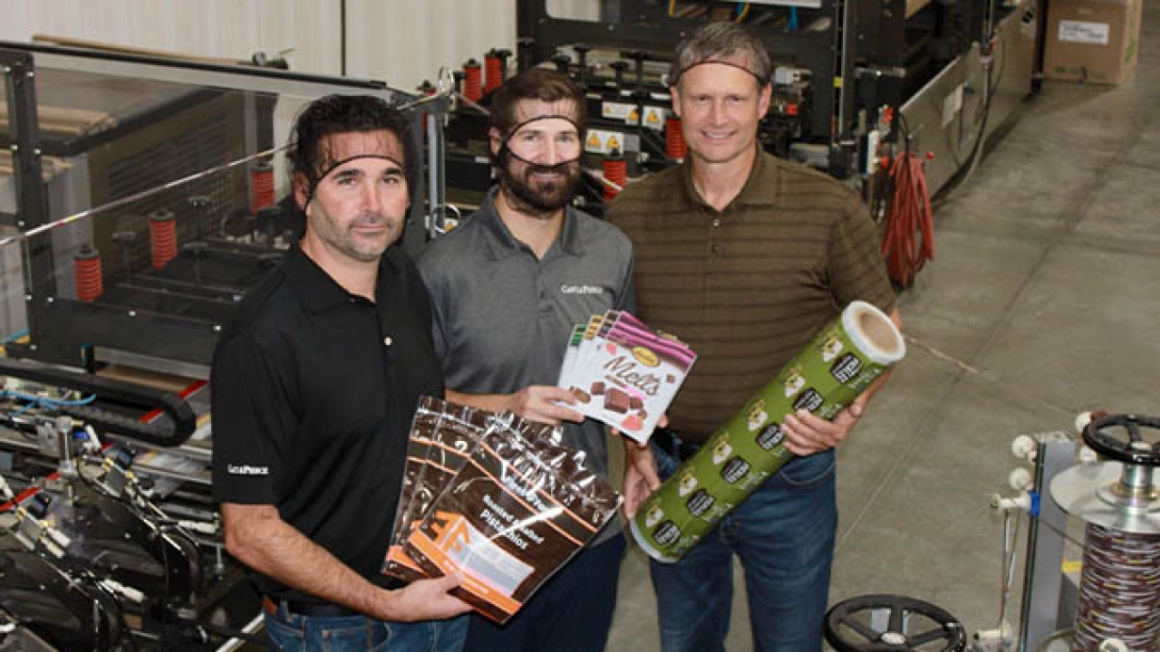 (L-R) Tom Castle-CEO, Will Wyman-operations manager, Jeff Elmer-plant manager standing in front of their new pouch converter (L-R) Tom Castle-CEO, Will Wyman-operations manager, Jeff Elmer-plant manager standing in front of their new pouch converter