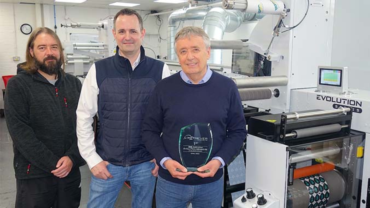 Retriever Sports’ managing director Ian Bennett with an award presented by Mark Andy’s Phil Baldwin (center) to commemorate the first Evolution Series E5 to be installed in the UK – with them is graphic designer Colin Raynsford