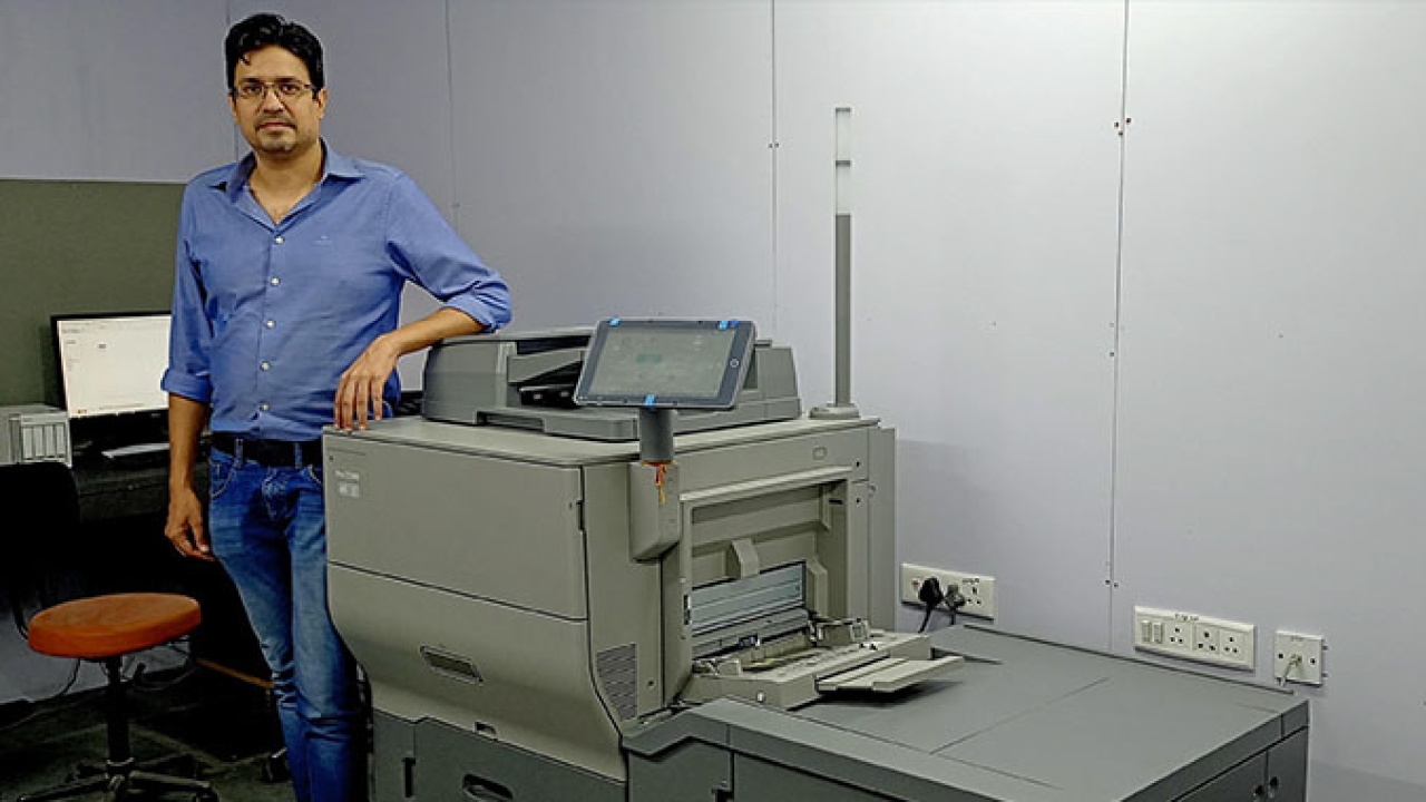 Nishant Sethi, CEO, Redray Global, in front of the newly installed Ricoh Pro C5300S digital print production system