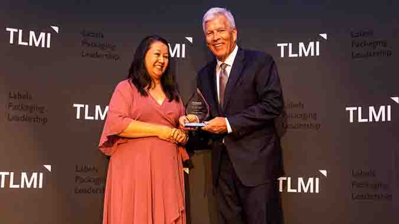Linda Casey (Packaging Impressions) presenting Craig Moreland with the TLMI 2021 Converter of the Year Award