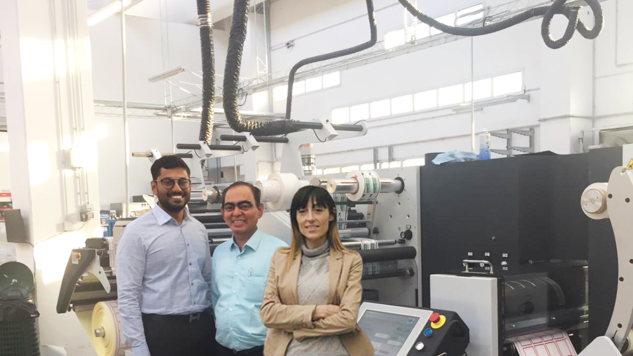 Hemanth Paruchuri (left) of Pragati Pack with Sunil Talpade (center) of Royal Coat with the new Digifast One finishing machine