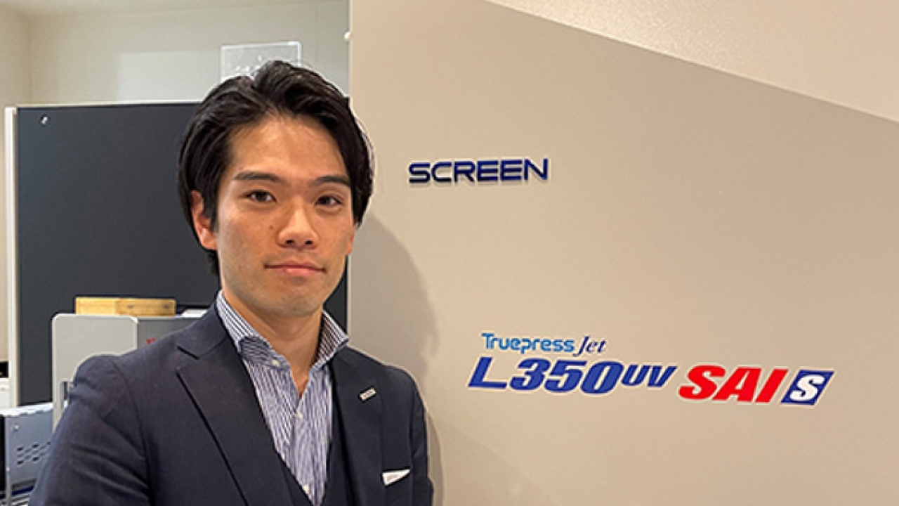 Taishi Motoshige, marketing manager of Screen Europe in front of a Truepress Jet L350UV SAI S