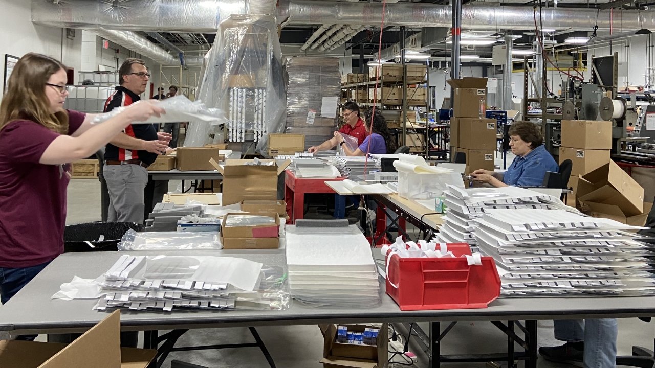 Employees at Metalcraft in Mason City, Iowa, work to assemble critical PPE