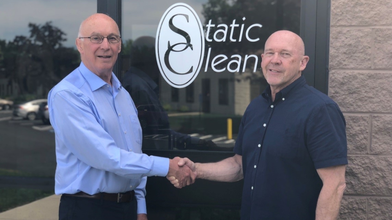 Jim Patterson (left), president of Static Clean, and Bob Fraser (right), managing director of Fraser Antistatic, shake hands on the deal