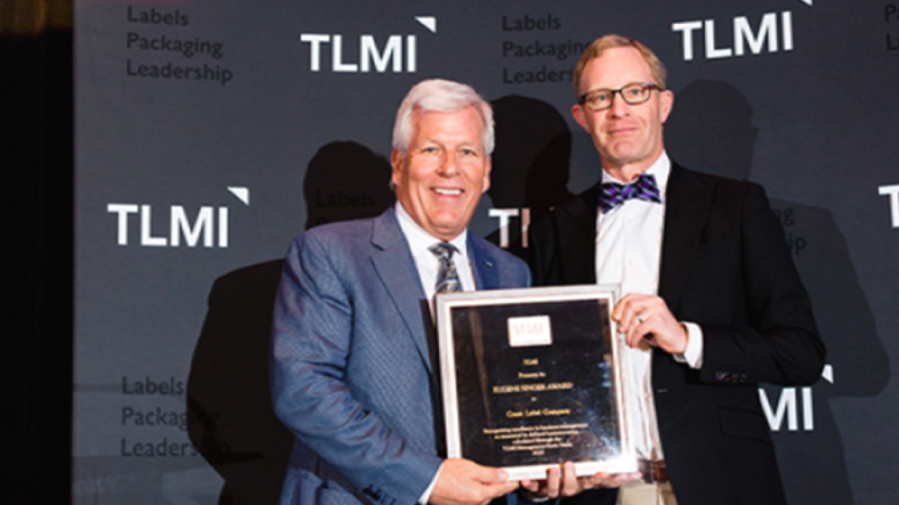 Craig Moreland, president of Coast Labels accepts the Eugene Singer Awards from TLMI chairman, Michael Ritter Craig Moreland, president of Coast Labels accepts the Eugene Singer Awards from TLMI chairman, Michael Ritter