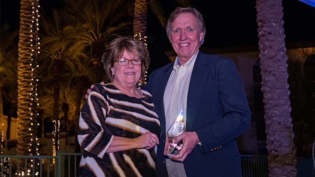 TLMI chair Lori Campbell presents Keith Grimm with the 2022 Volunteer of the Year Award 
