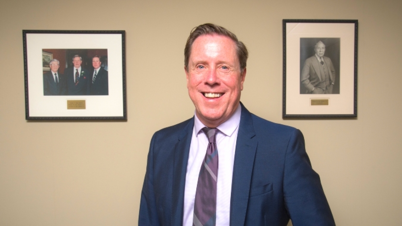 Nick VanAlstine with photographs of his father and grandfather 