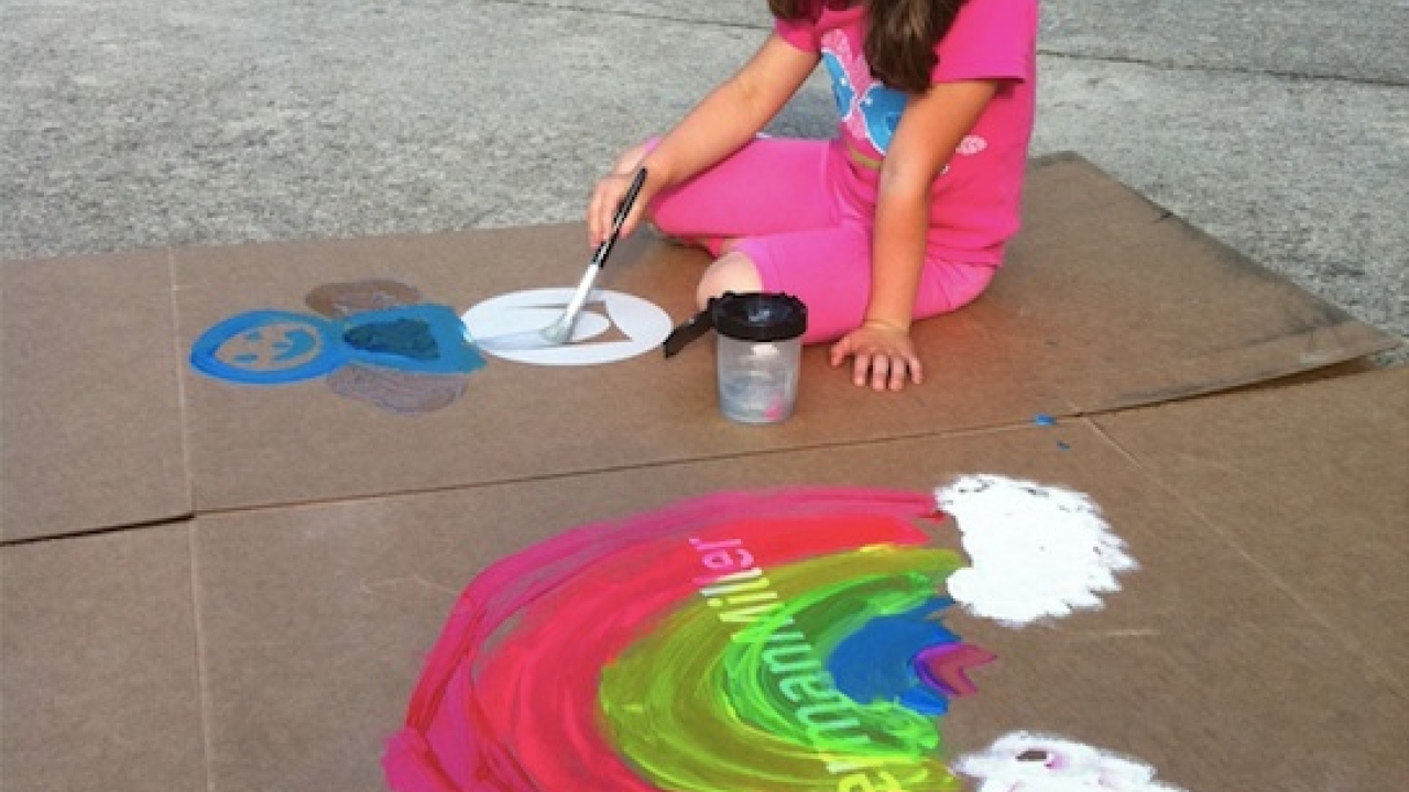 Vicki Strull’s daughter, Eden, reusing an empty furniture box as a canvas