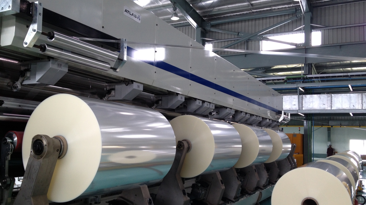 As part of the latest investment, Cosmo Films has installed two slitter rewinders from Atlas – a 8.7m-wide Atlas CW984AP primary film slitter at the end of the film line and a 2.8m-wide Atlas CW800 secondary film slitter for processing narrower widths of BOPP film. As part of the latest investment, Cosmo Films has installed two slitter rewinders from Atlas – a 8.7m-wide Atlas CW984AP primary film slitter at the end of the film line and a 2.8m-wide Atlas CW800 secondary film slitter for processing narrower widths of BOPP film.