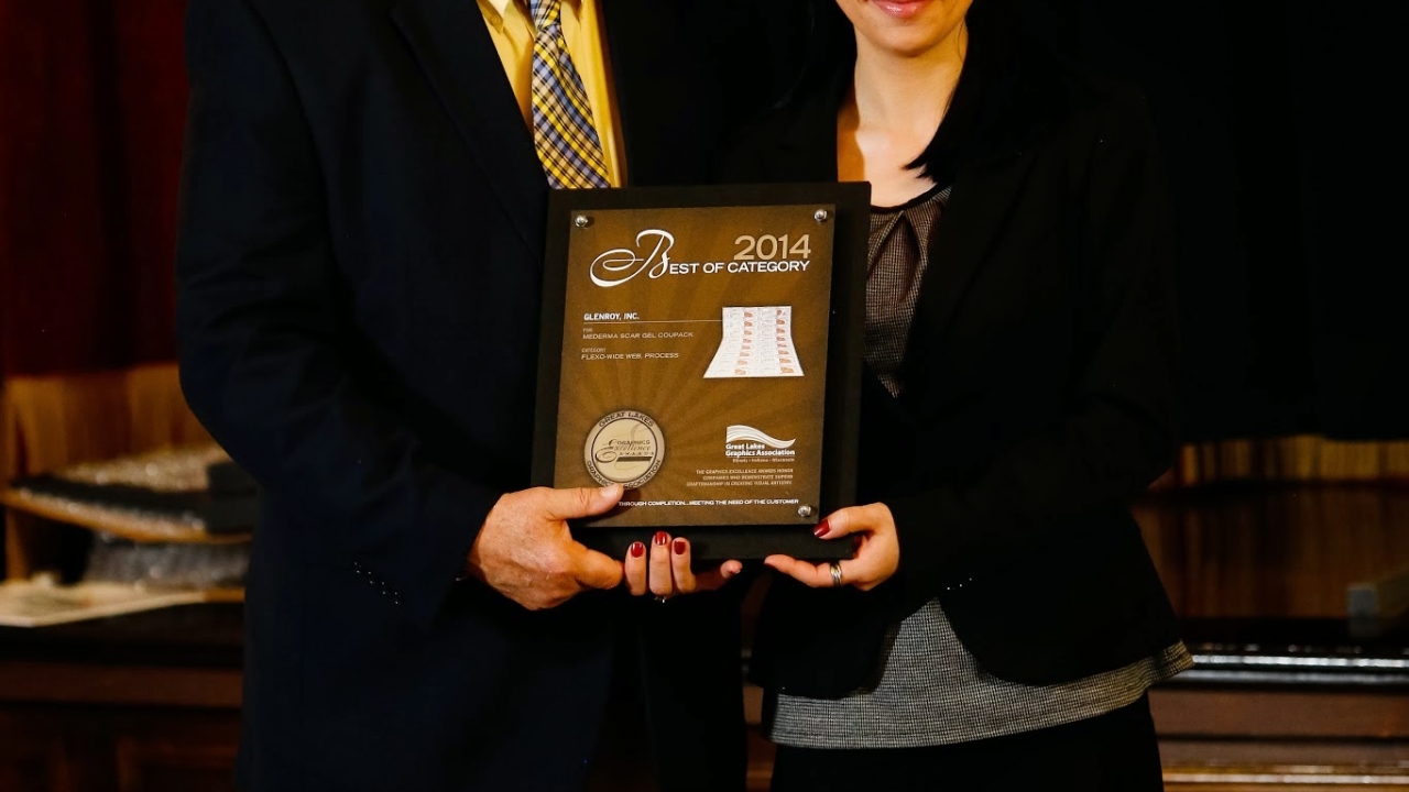 Leah Janke of Glenroy accepts a Great Lakes Graphics Association Best of Category award