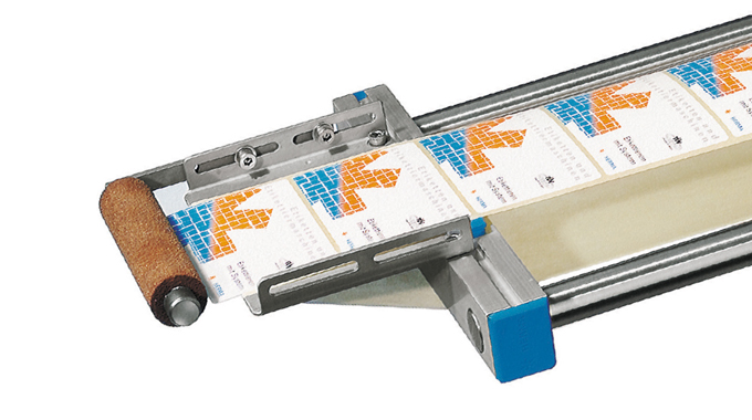 Figure 2.11 - Use of a roller to press the label to the product or pack. Courtesy of Herma