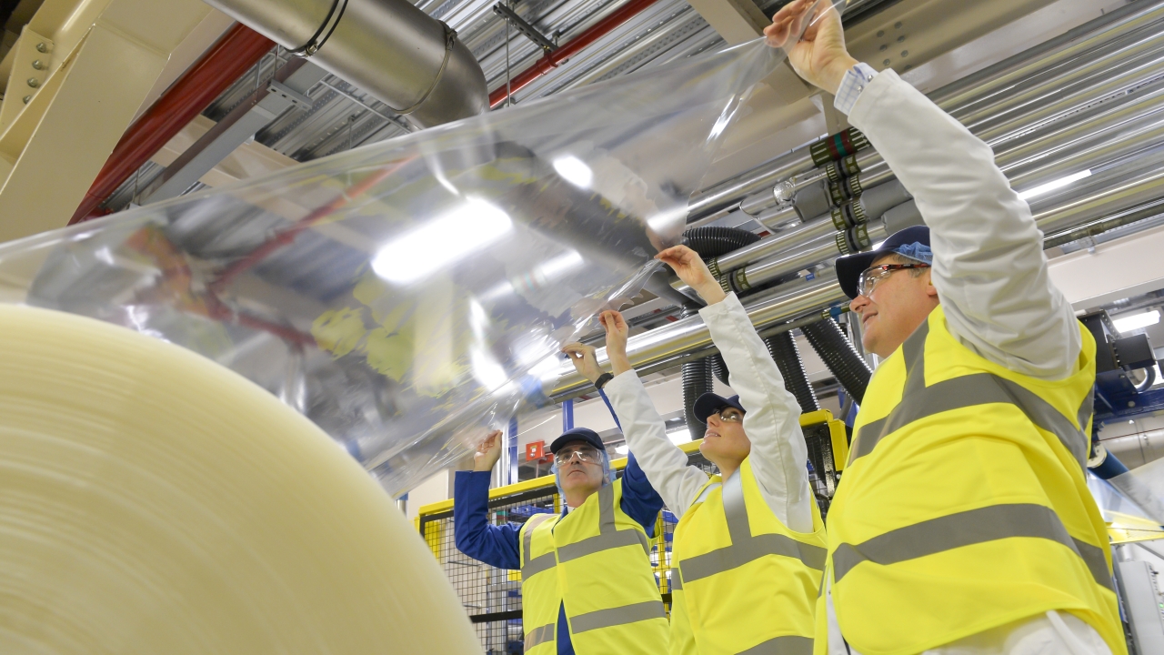 Pictured (from left): Innovia Group CEO Mark Robertshaw, Bank of England chief cashier Victoria Cleland and Innovia Films managing director Joe Piccione inspecting a reel of Clarity C film at the end of the new bubble line